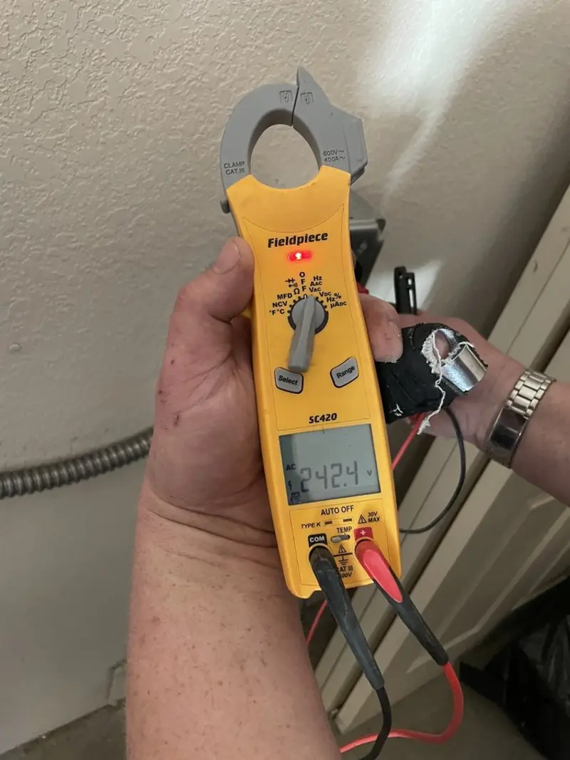 Voltage testing with clamp meter during Ceiling Fan Installation in Pflugerville